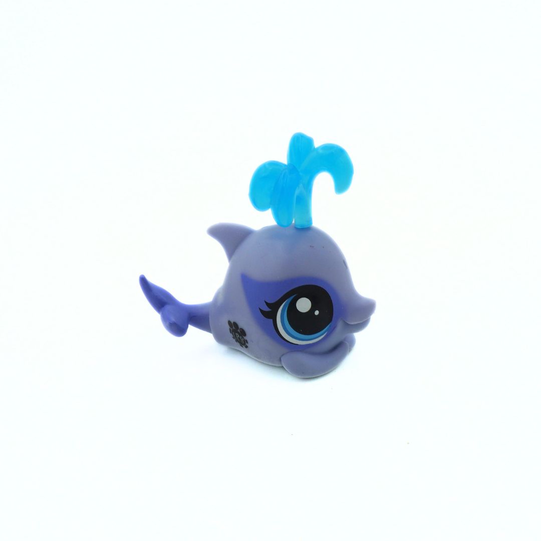 Small blue toy figure with a large eye on a white background