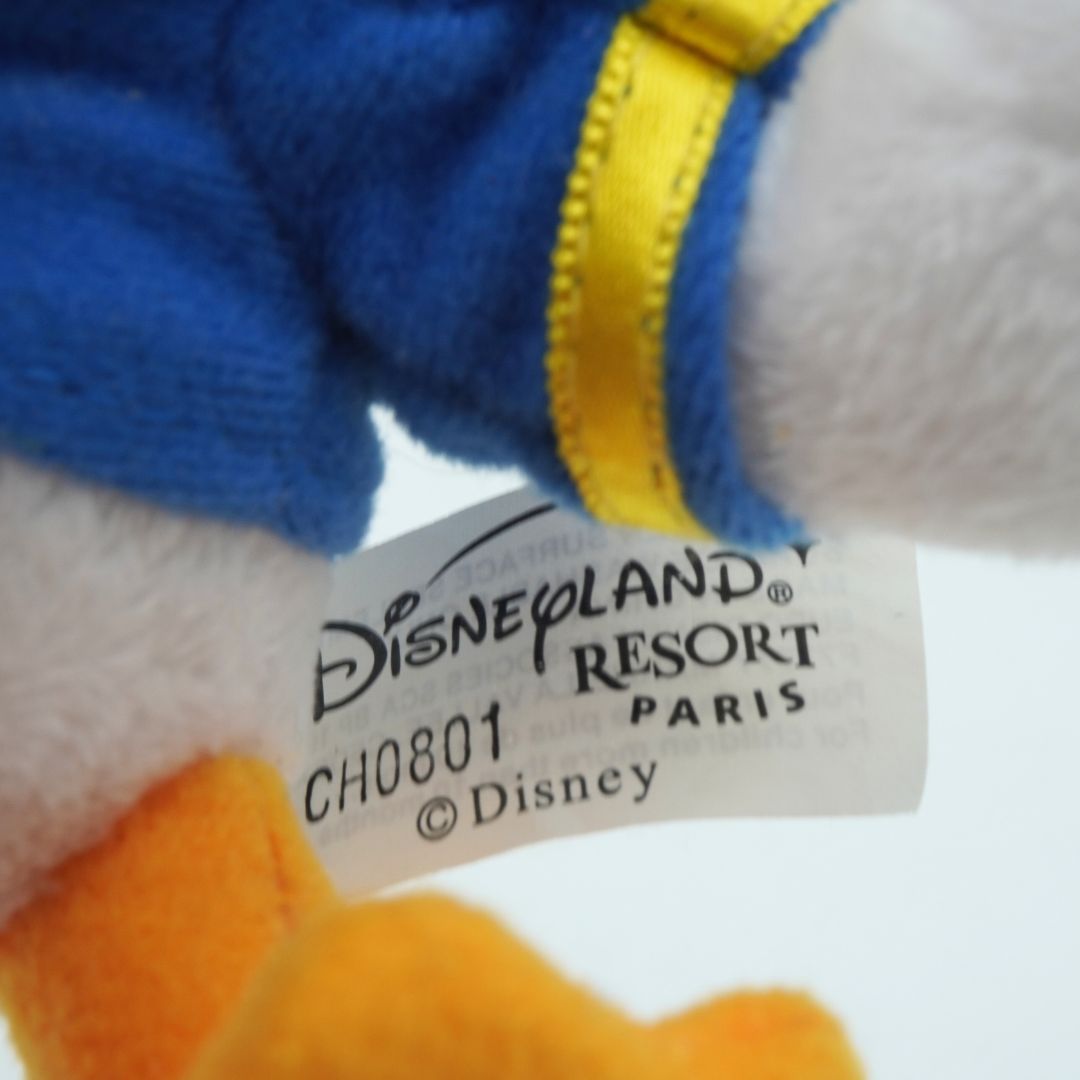 Close-up of a Disneyland Resort Paris tag on a plush toy.