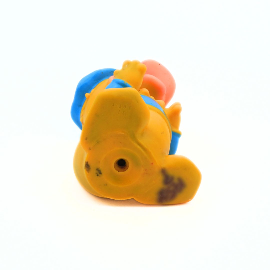 Yellow toy with blue and red accents on a white background