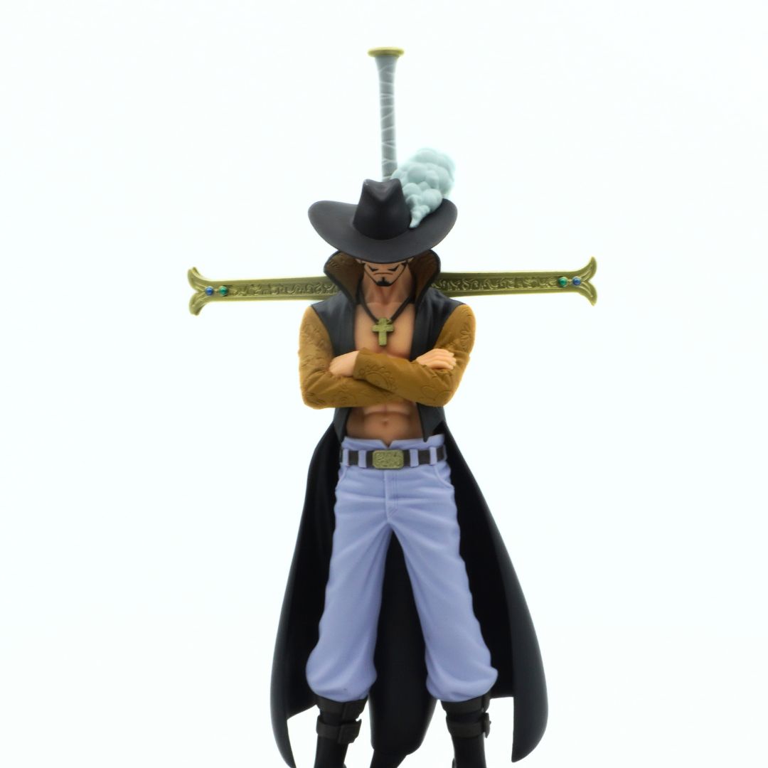 Closeup of a Dracule Mihawk figurine showing his cross necklace, blue pants and iconic sword