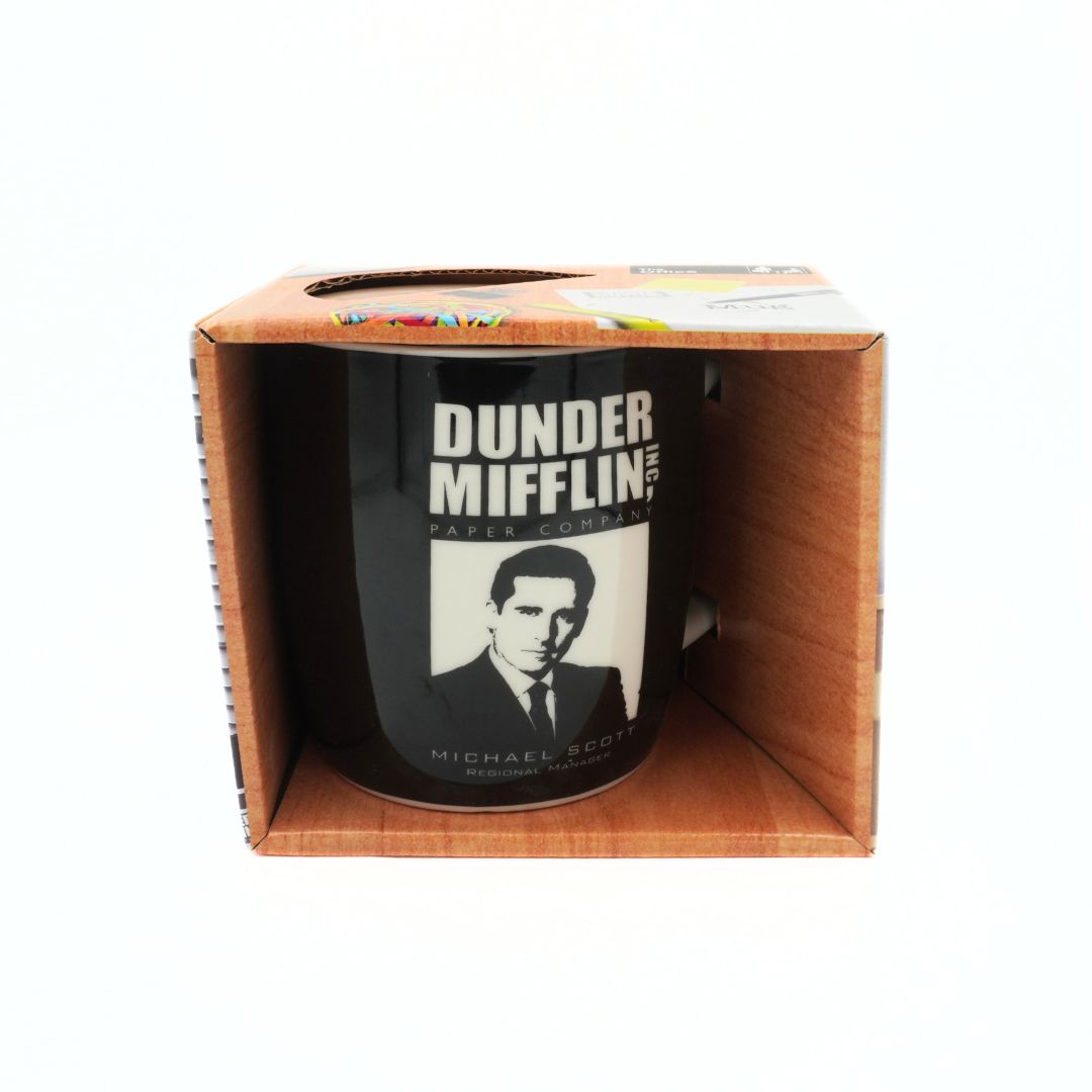 Black mug with 'Dunder Mifflin' logo and Michael Scott image in a cardboard box packaging.