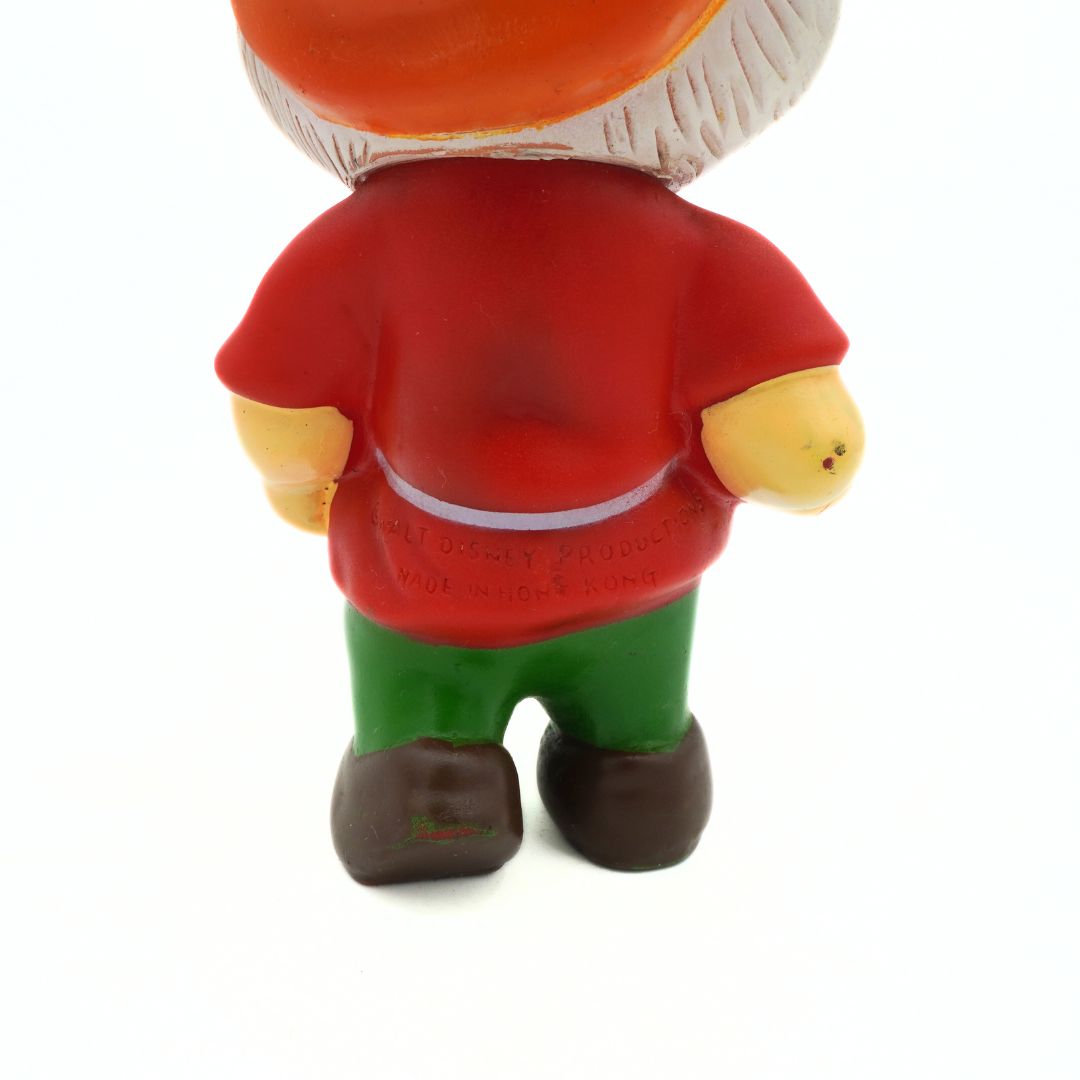 Toy figure with a red shirt, green pants, and mushroom hat on a white background