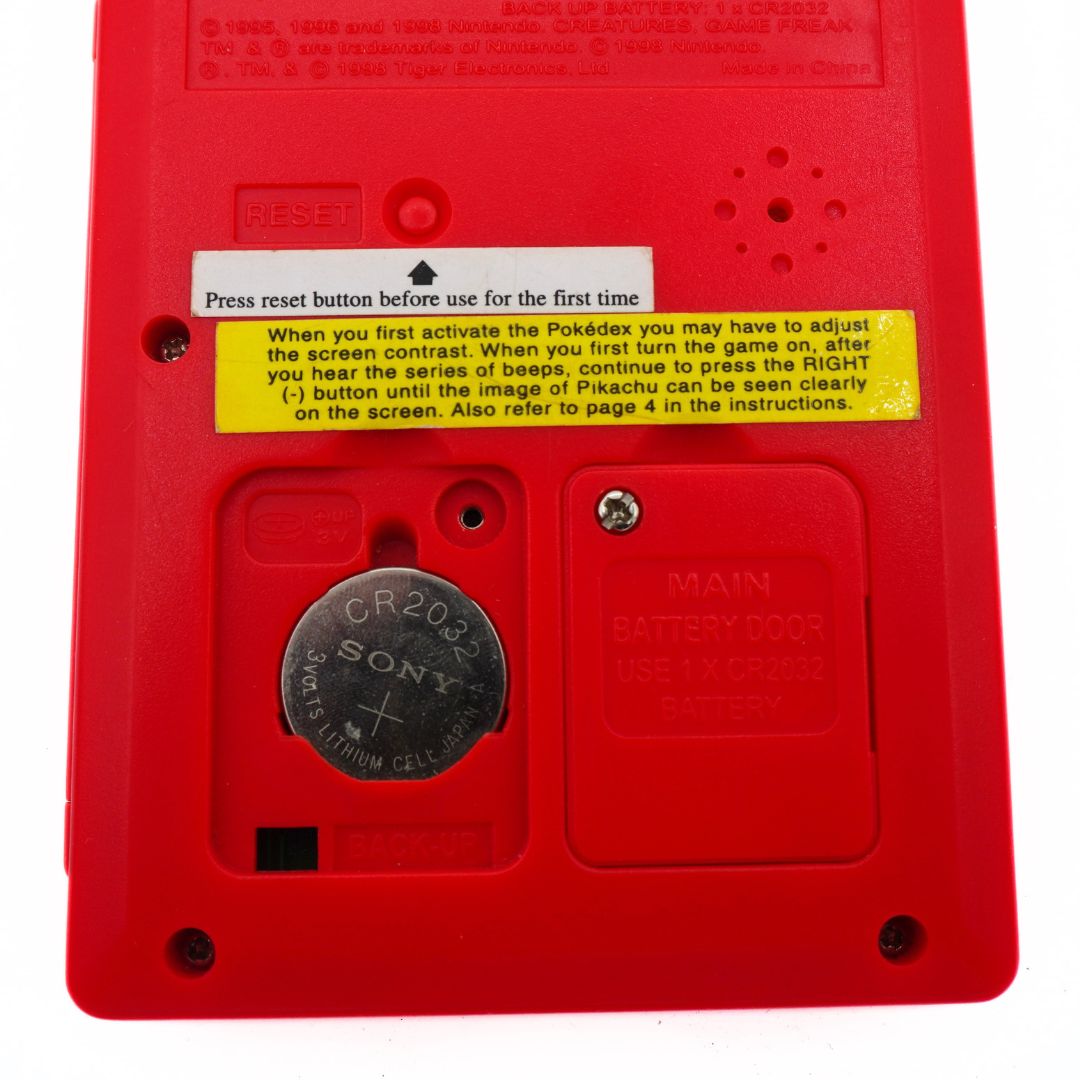 Red Pokédex with battery compartment and label on a white background