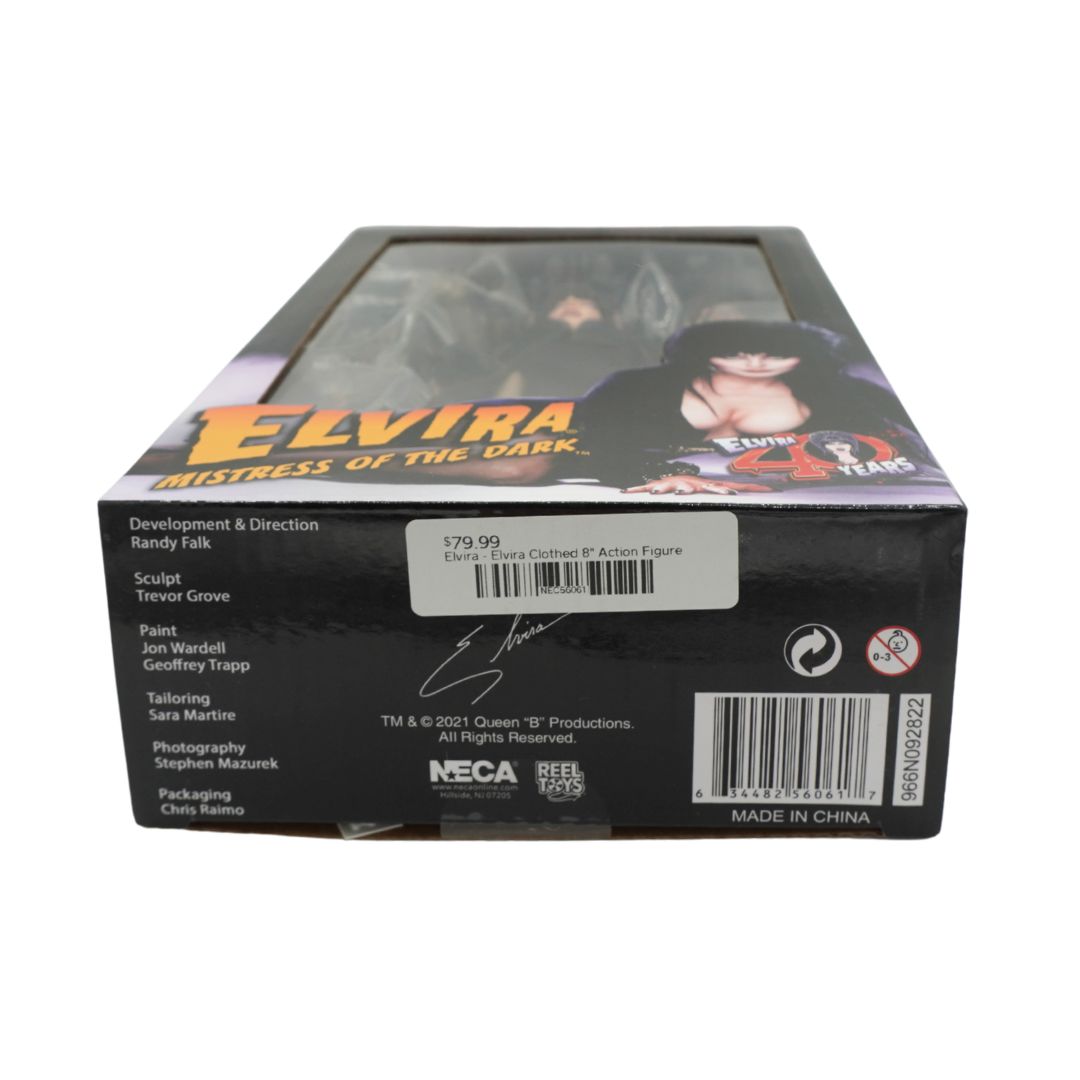 The product packaging box for 'Elvira Mistress of the Dark' action figure, showing the back side with credits, a barcode, and a white price sticker on a white background.