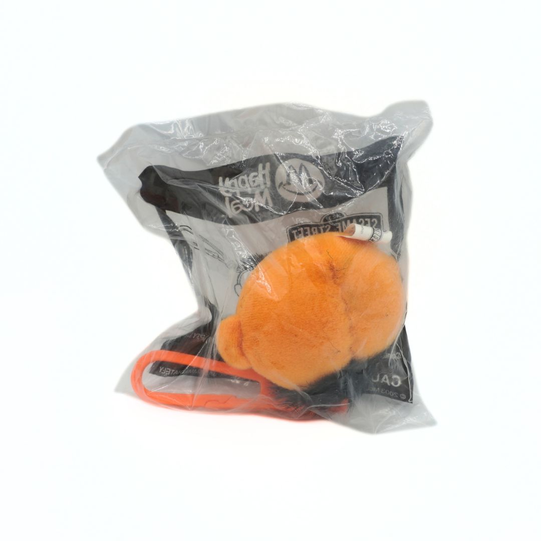 Orange toy with packaging on a white background