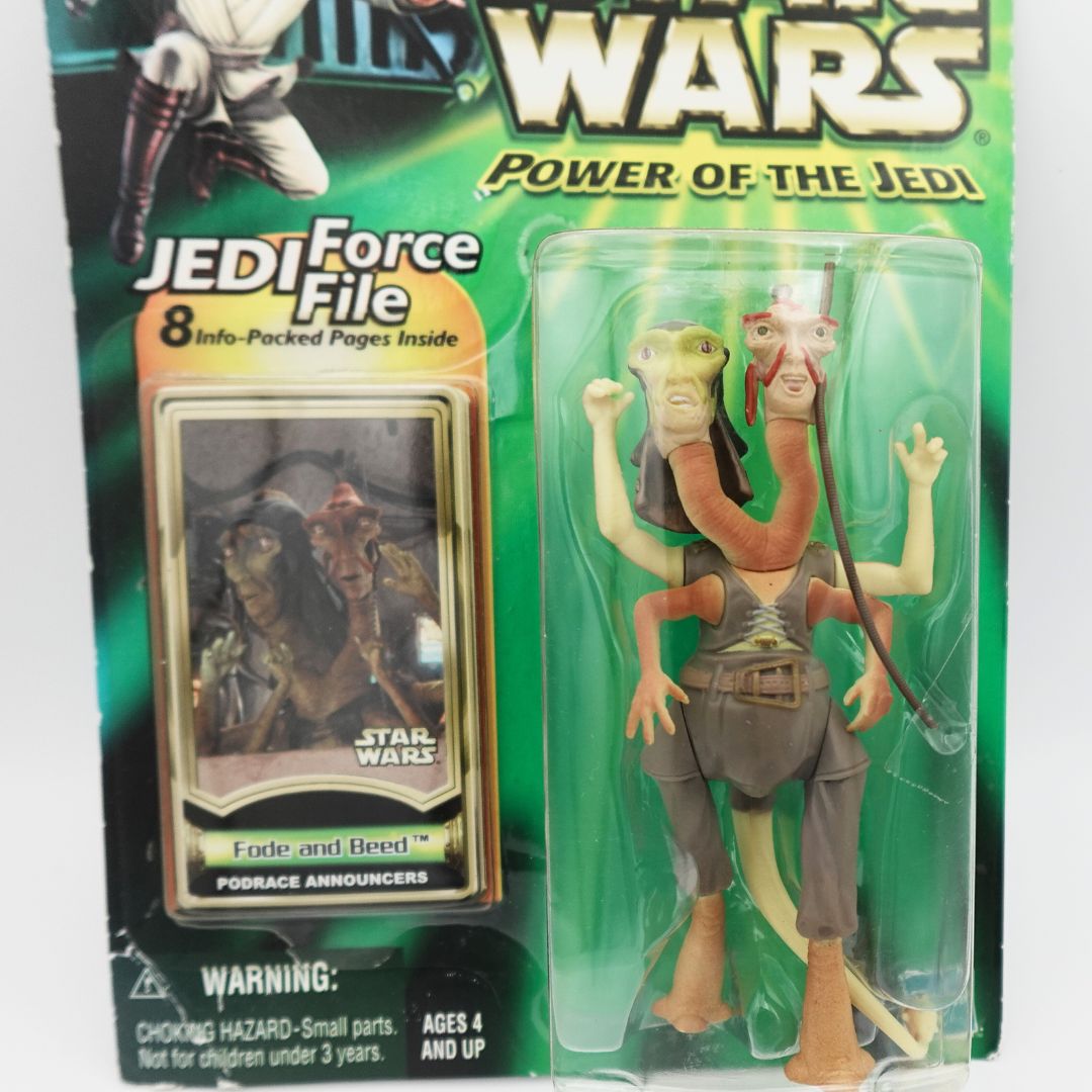Closeup of the Fode and Beed figurine still in its original packaging with a Jedi Force File included