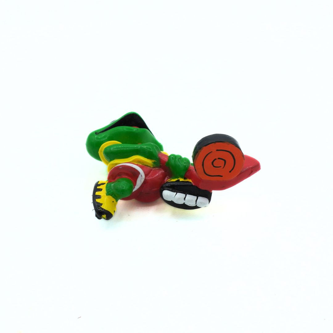 Colorful figurine of a character with green, red, and black colors on a white background