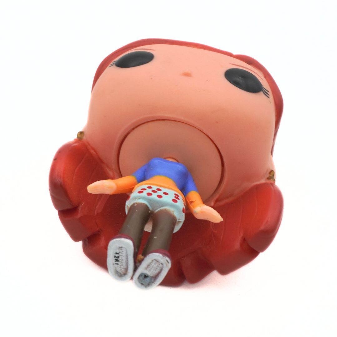 Toy figure of a character with a large red head and body on a white background