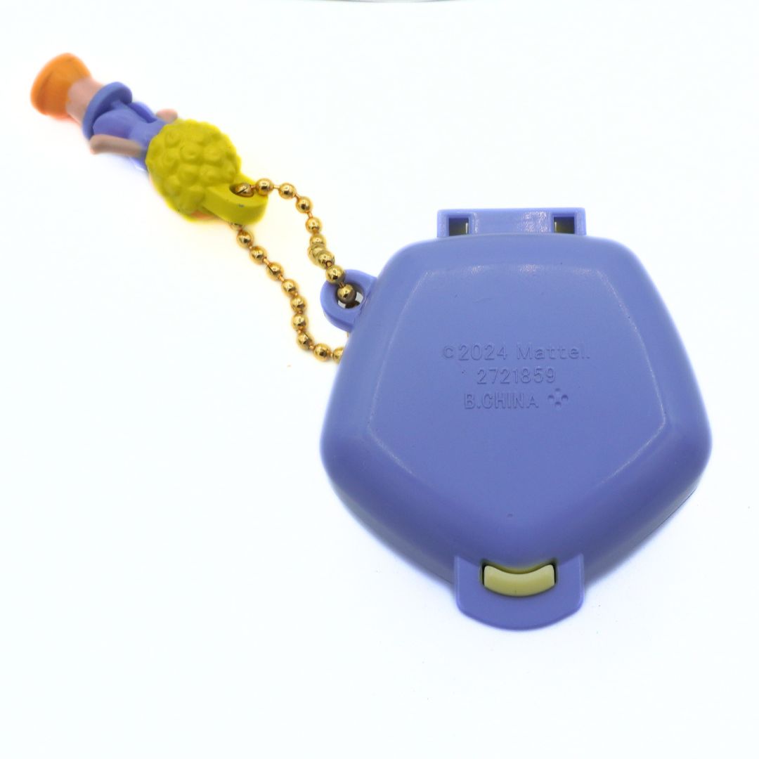Purple toy with a chain and small figure on a white background