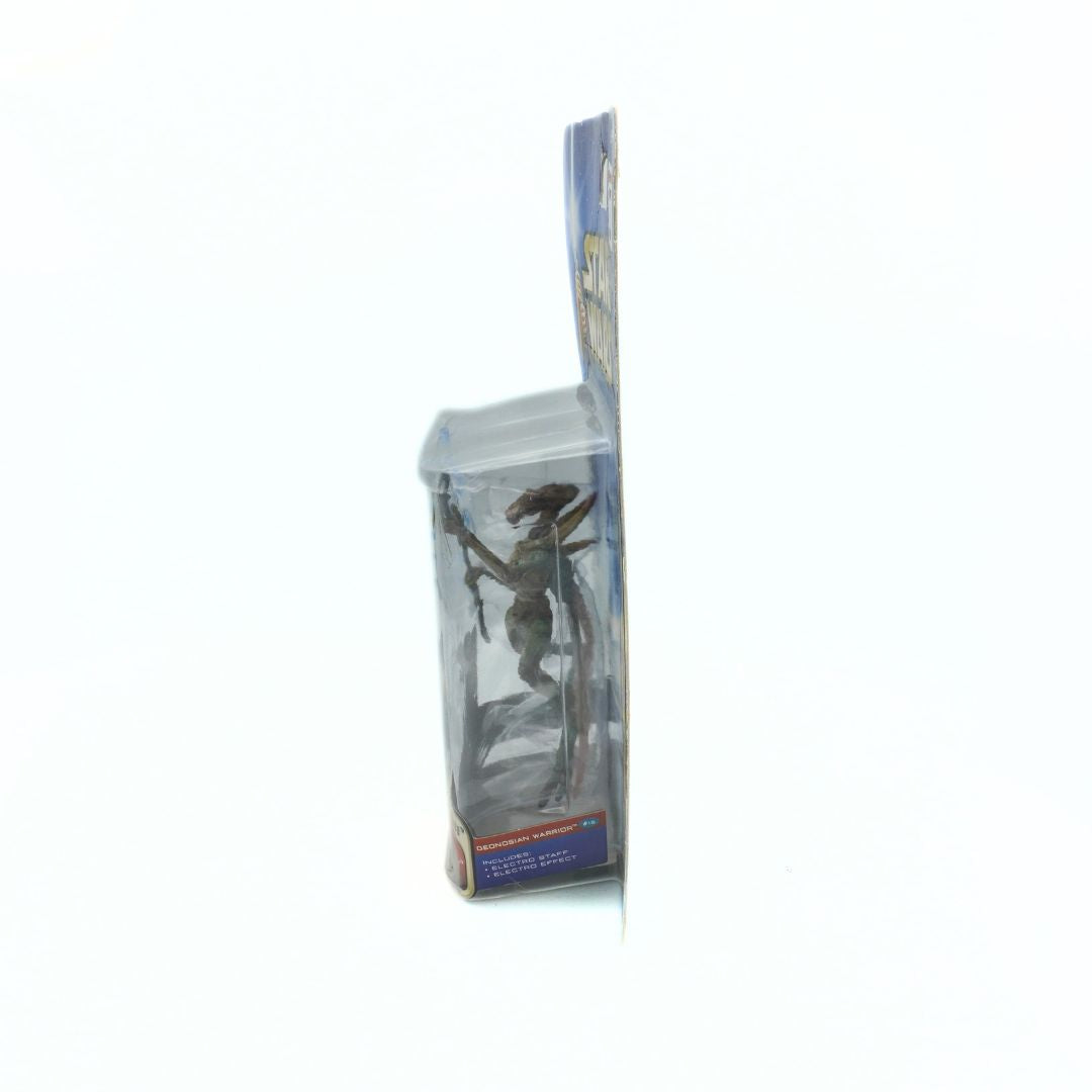 Side on photo of a 2001 Geonosian Warrior figurine in its original packaging