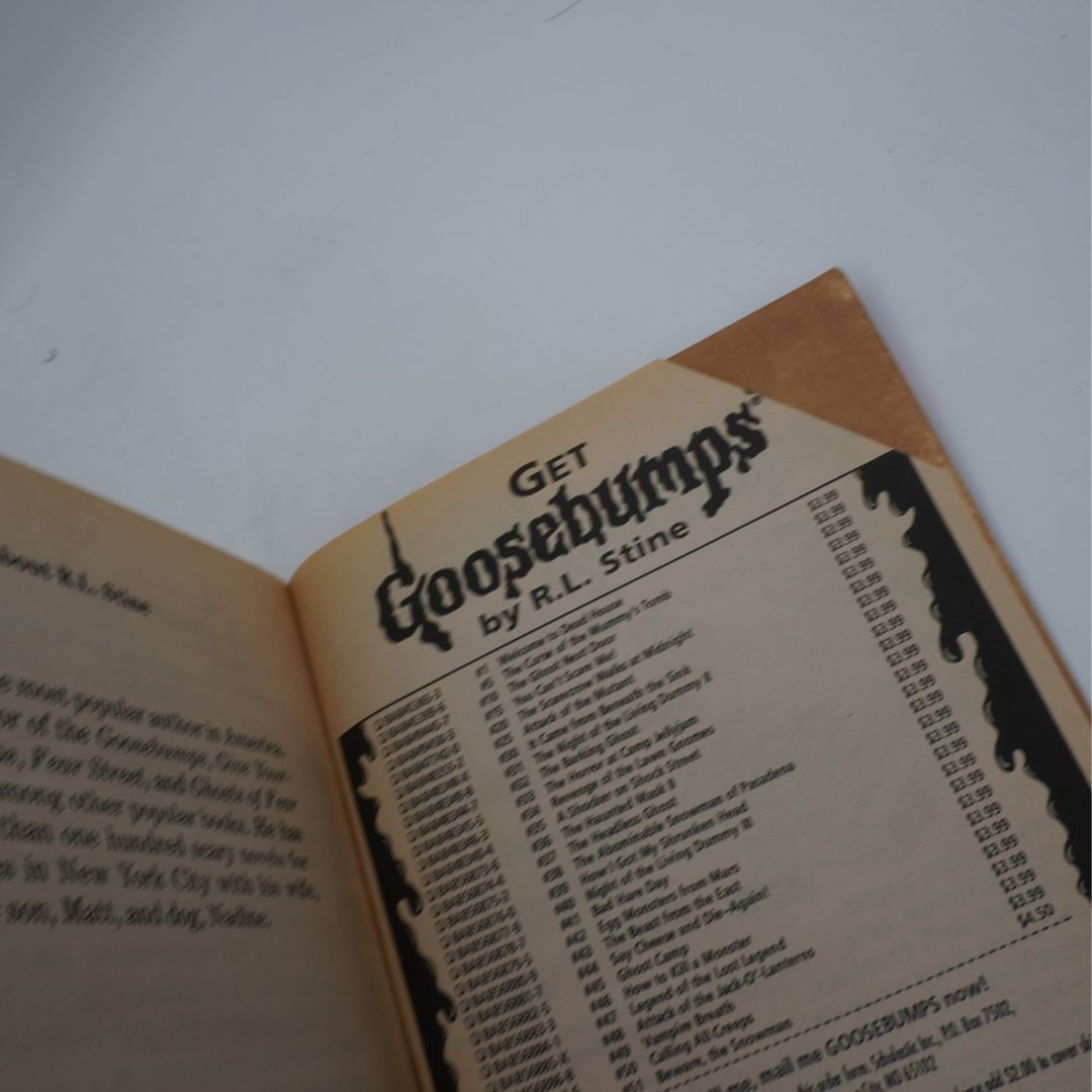 Open book with 'Goosebumps' by R.L. Stine on a white background