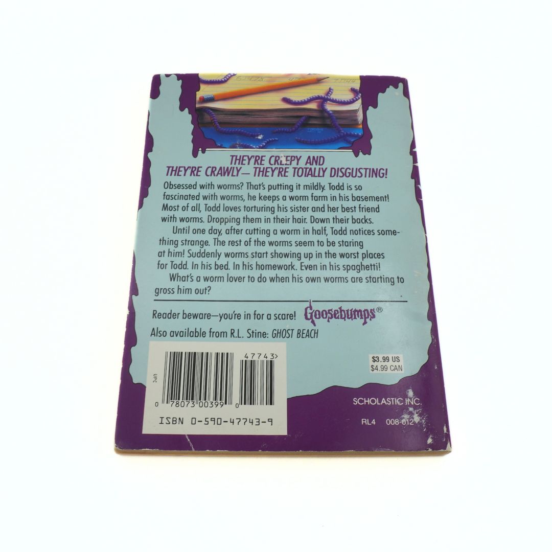 Back cover of a Scholastic book with text and a barcode on a white background