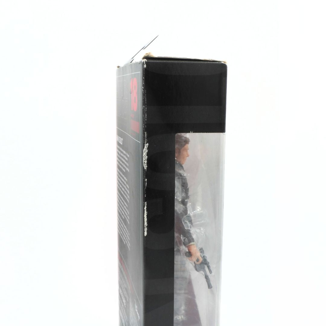 Action figure in packaging with visible branding on a white background