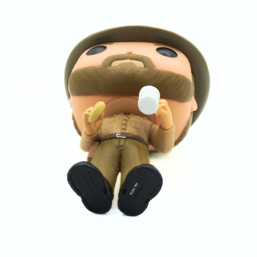 Toy figure of a man with a beard and hat holding a megaphone on a white background