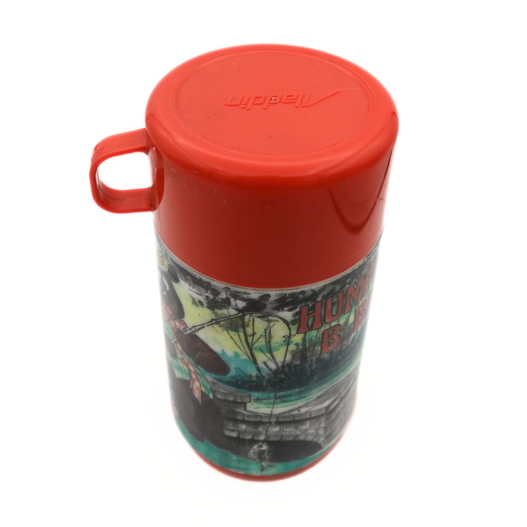 Top down photo of a red and green Aladdin Humphrey Bear thermos