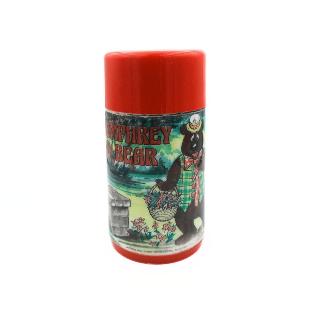 Front on photo of the red and green 60s Aladdin Humphrey Bear Flask with Aladdin branding at the bottom