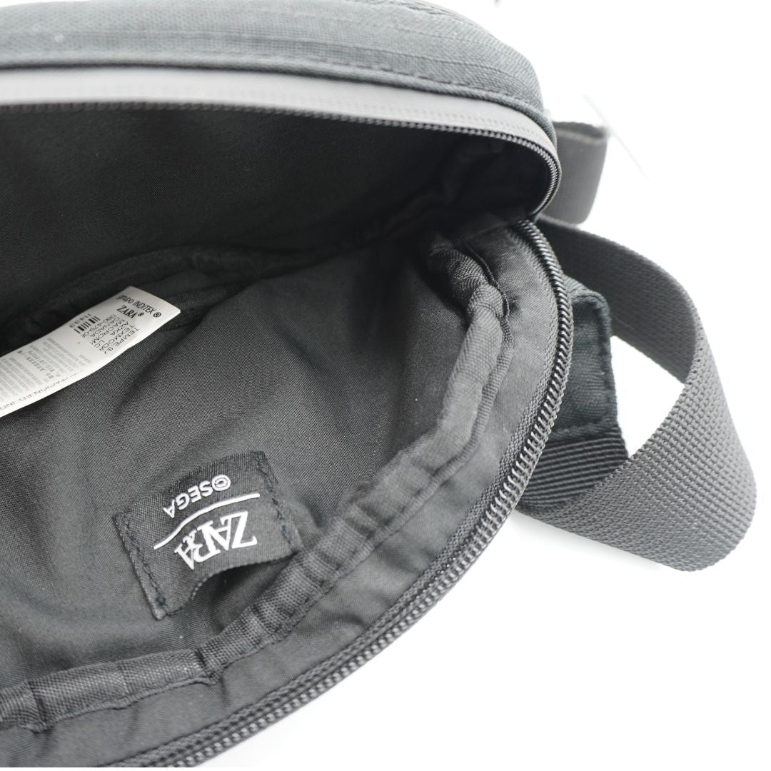 A black and white bumbag/fanny pack with a Sega Mega Drive controller design
