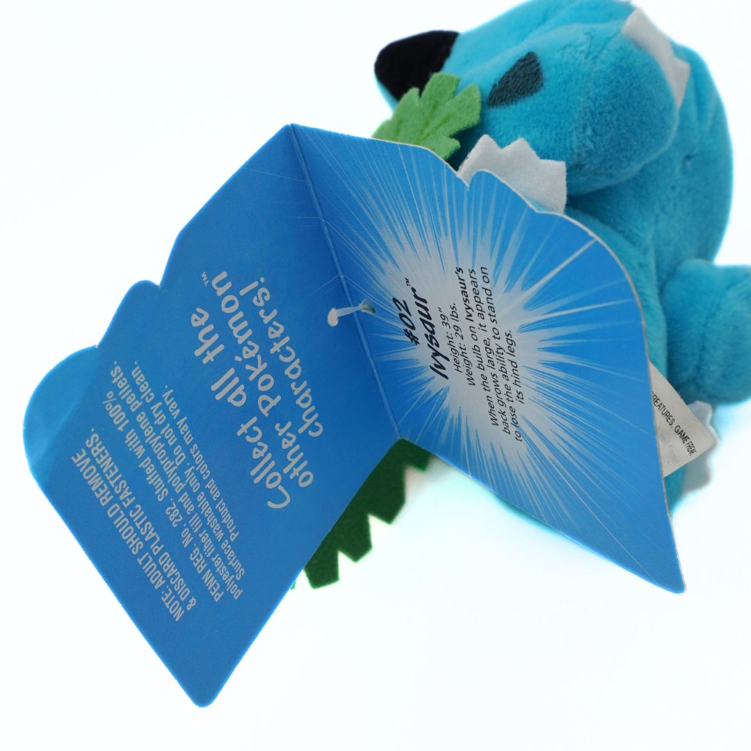 Blue plush toy with a blue card attached on a white background
