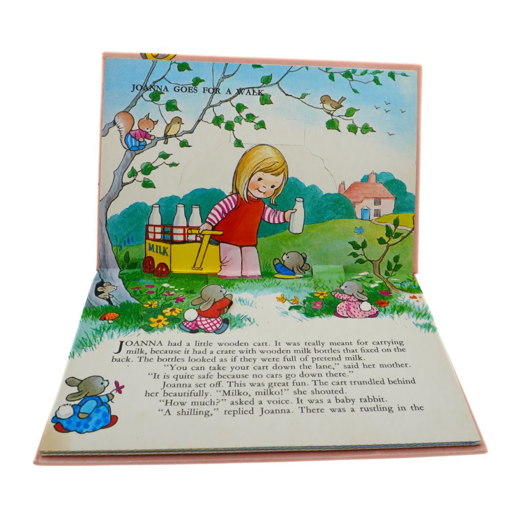 Pop up book page for the story Joanna Goes For A Walk featuring a colourful illustration of a child with a milk trolley