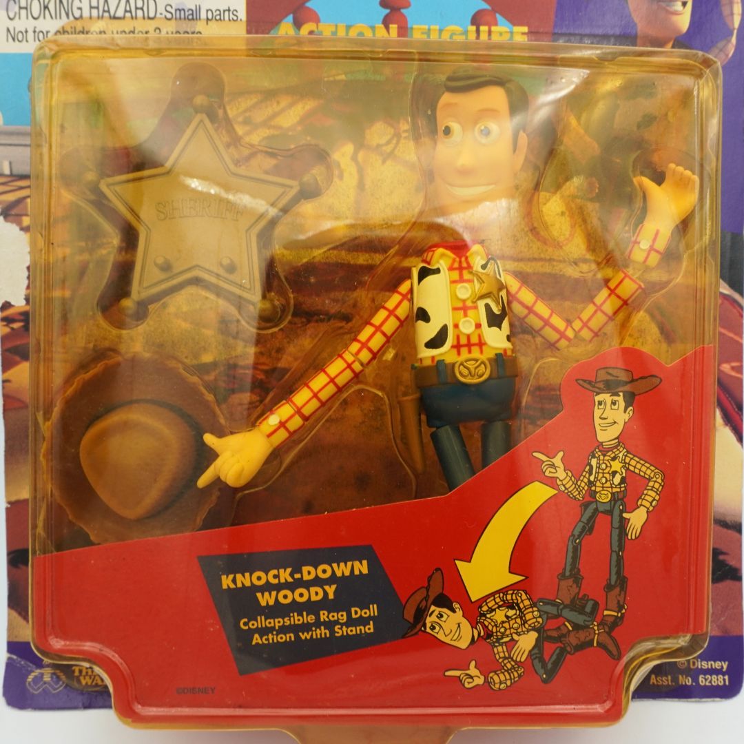 Closeup of a 1995 Woody Knock-Down Doll with his sheriff badge and hat
