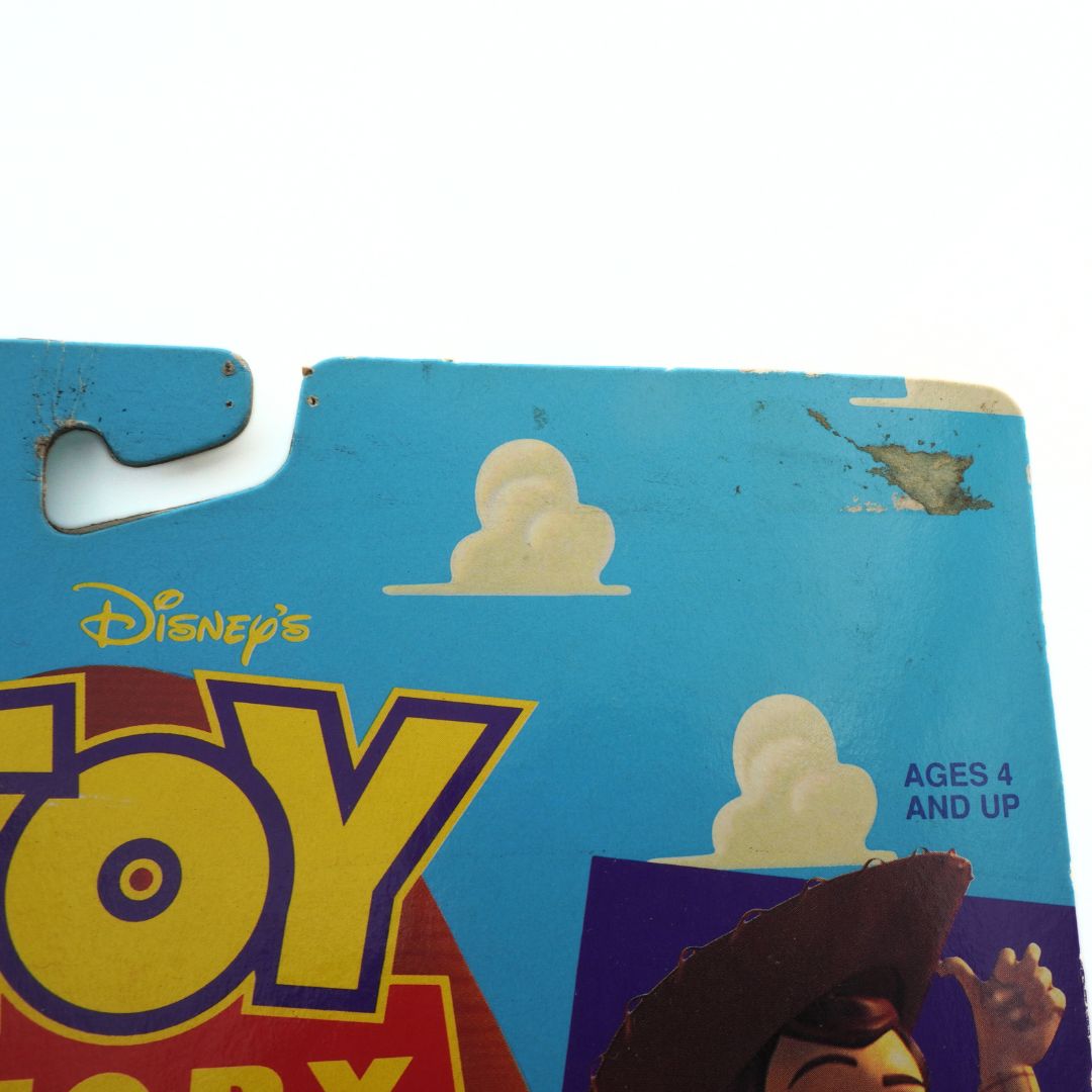 Corner of a 1995 Knock Down Woody toy from Toy Story showing some minor marks