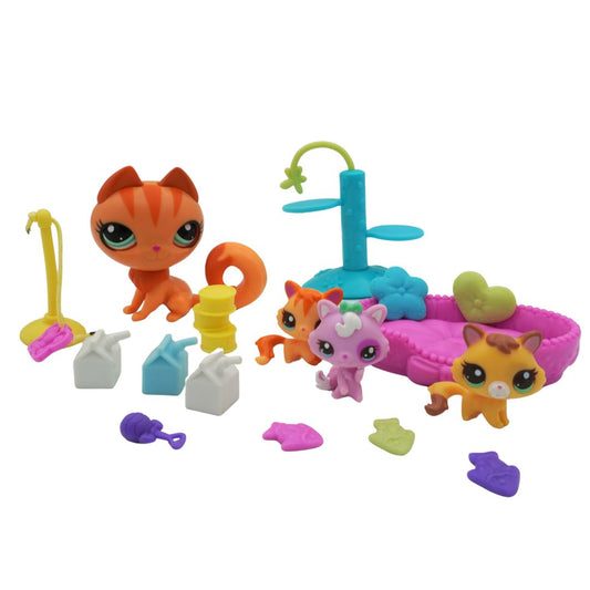 Colorful toy set with small animal figures and accessories on a white background