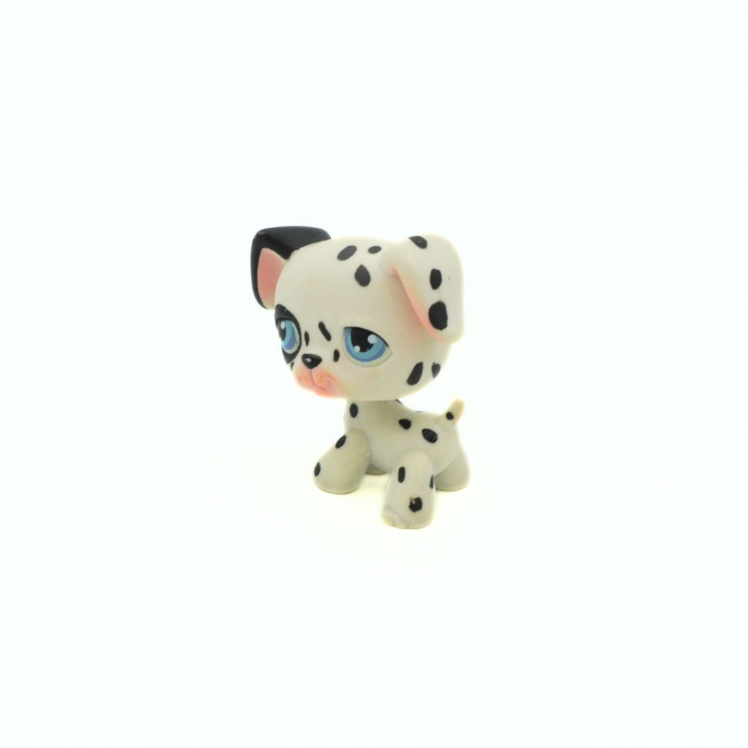 Small figurine of a dalmatian dog with black spots on a white background