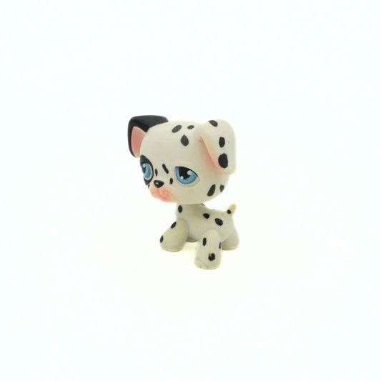 Small figurine of a dalmatian dog with black spots on a white background