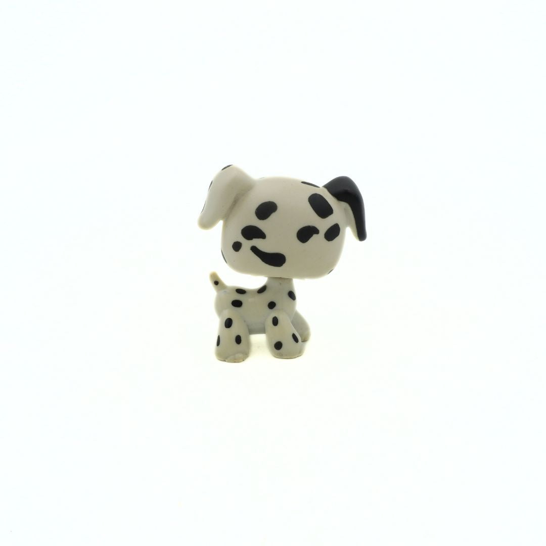Small Dalmatian dog figurine on a white background
