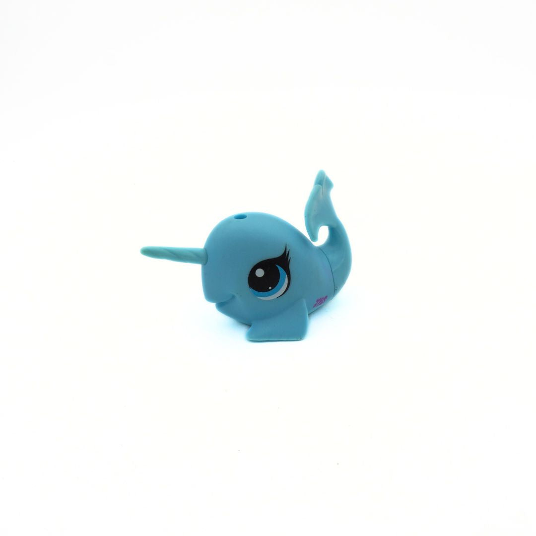 Small blue toy narwhal on a white background