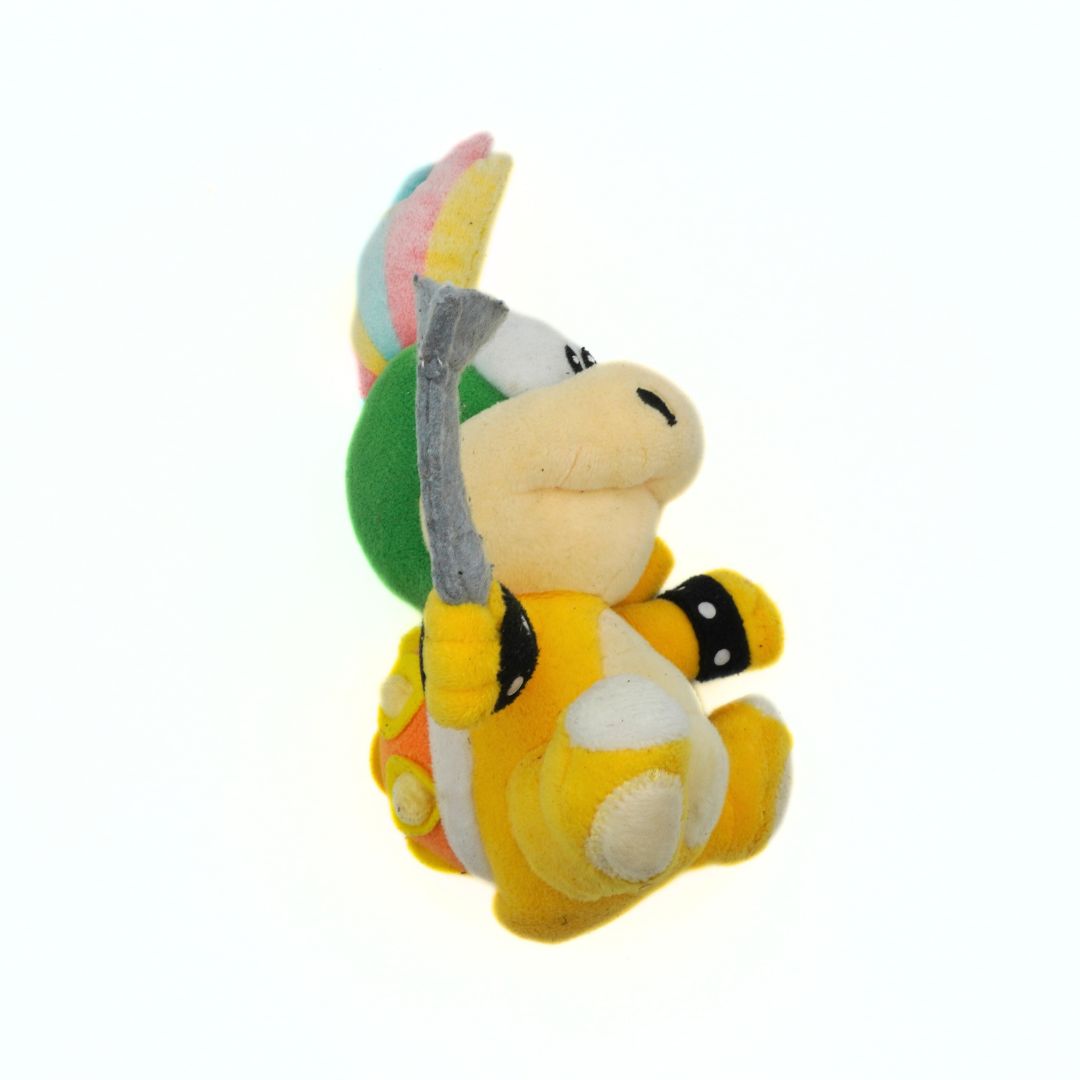 Plush toy of a character with a colorful shell on a white background