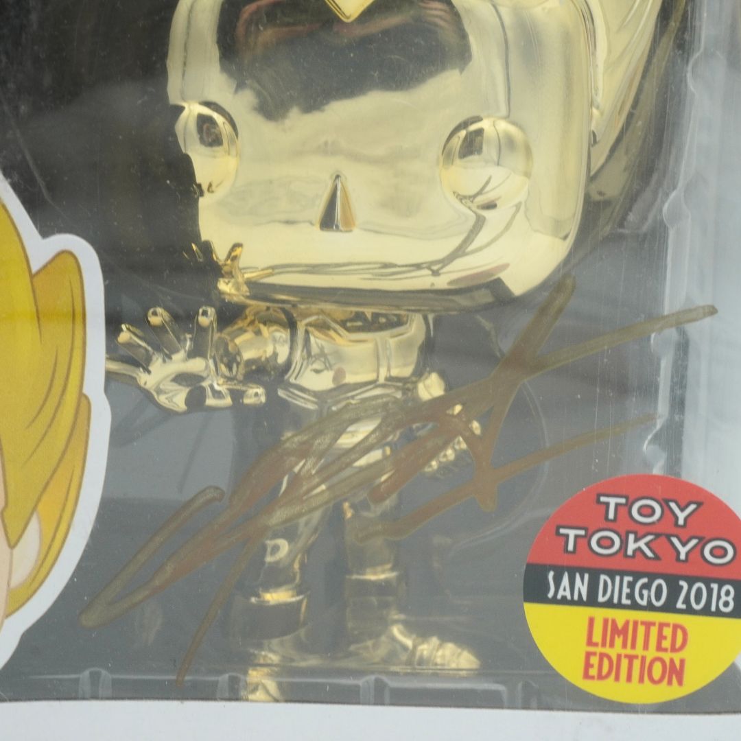 Gold Funko figure in packaging with 'Toy Tokyo' label