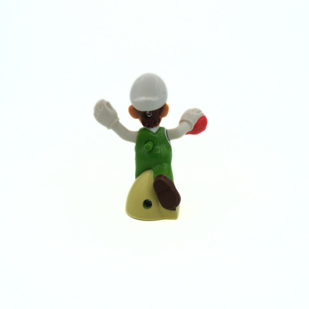 Toy figure of Luigi seen from behind, wearing a green outfit with a white cap on a white background