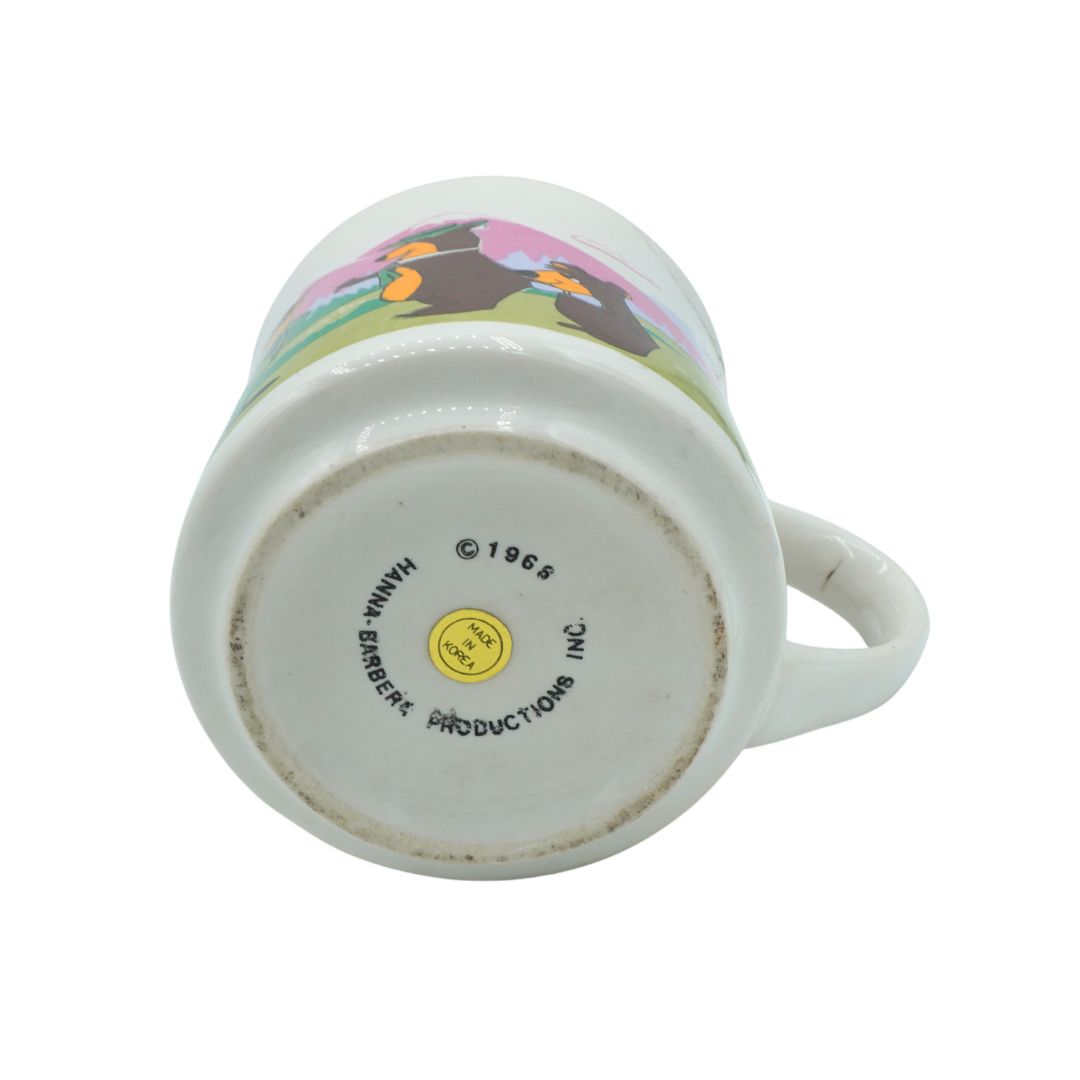 Ceramic mug with cartoon character design on a white background