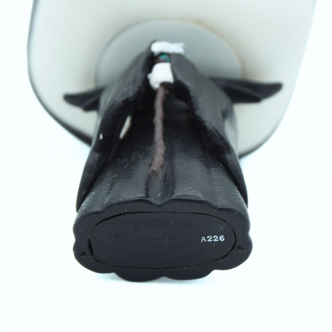 Underside of a 2014 Maleficent pop vinyl, where is is holding a brown staff and dressed in black robes