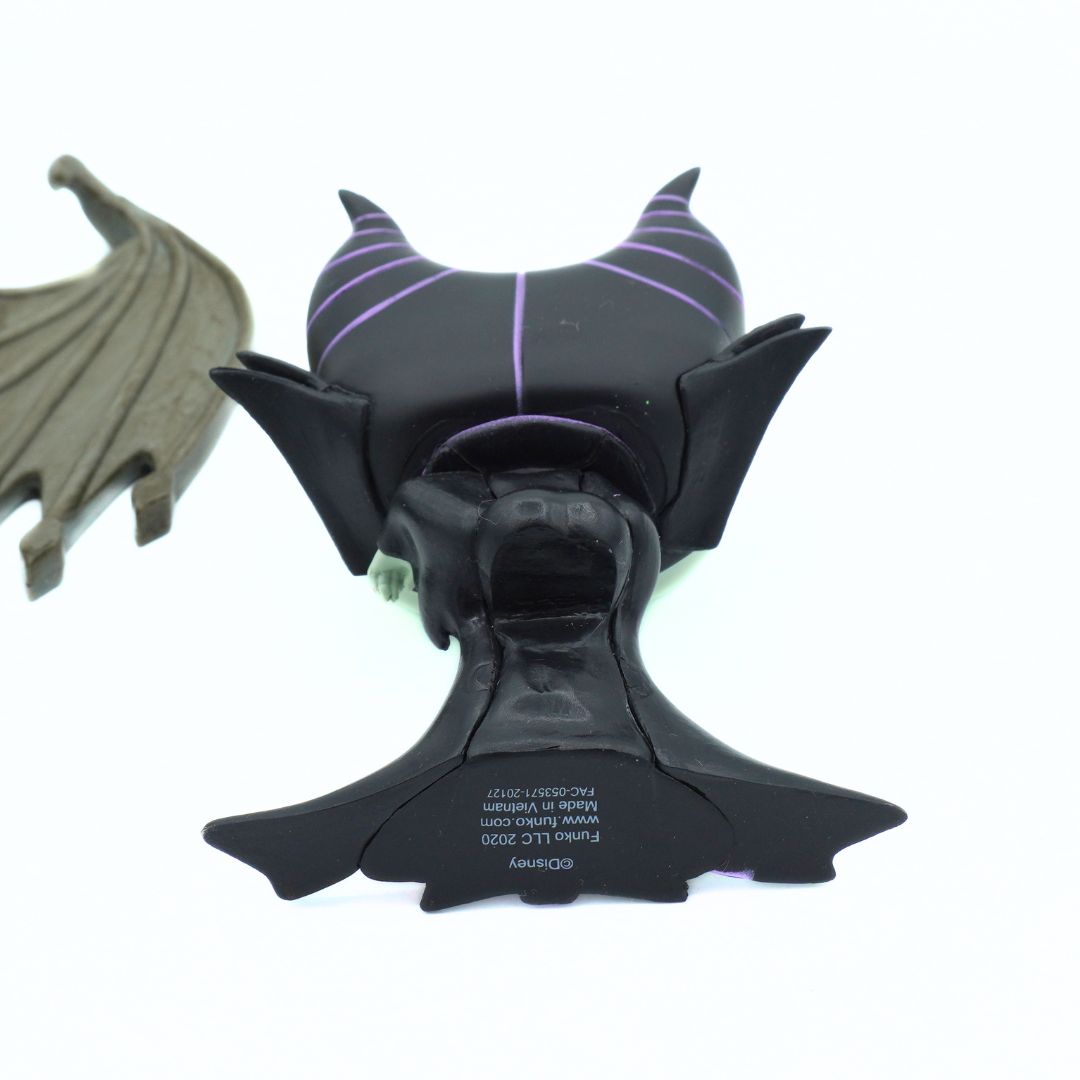 Black and purple character figurine with bat wings on a white background