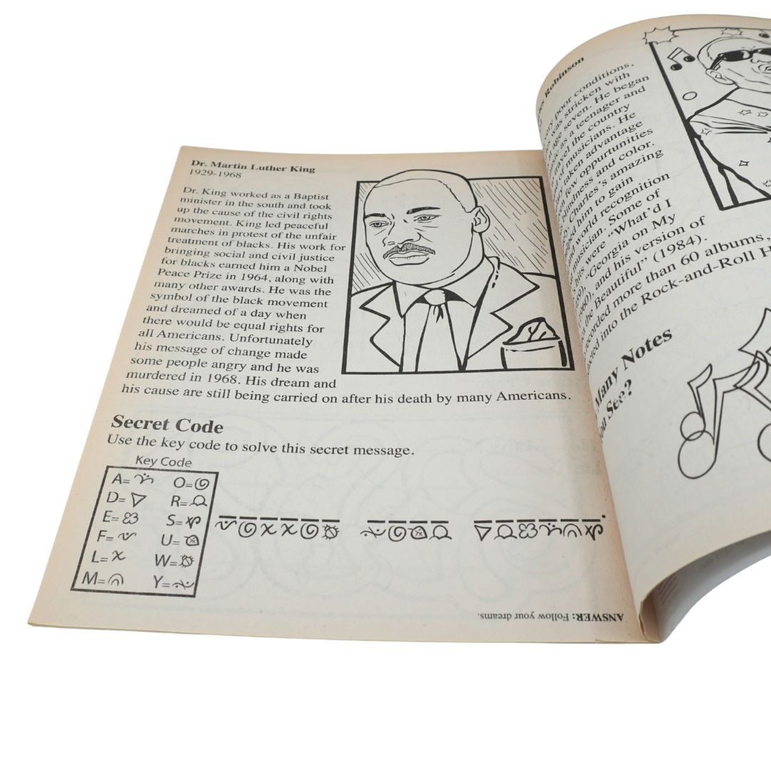 An open vintage book or magazine spread showing printed text, a black-and-white portrait illustration, and a secret code exercise on the left page, with a comic panel on the right page.