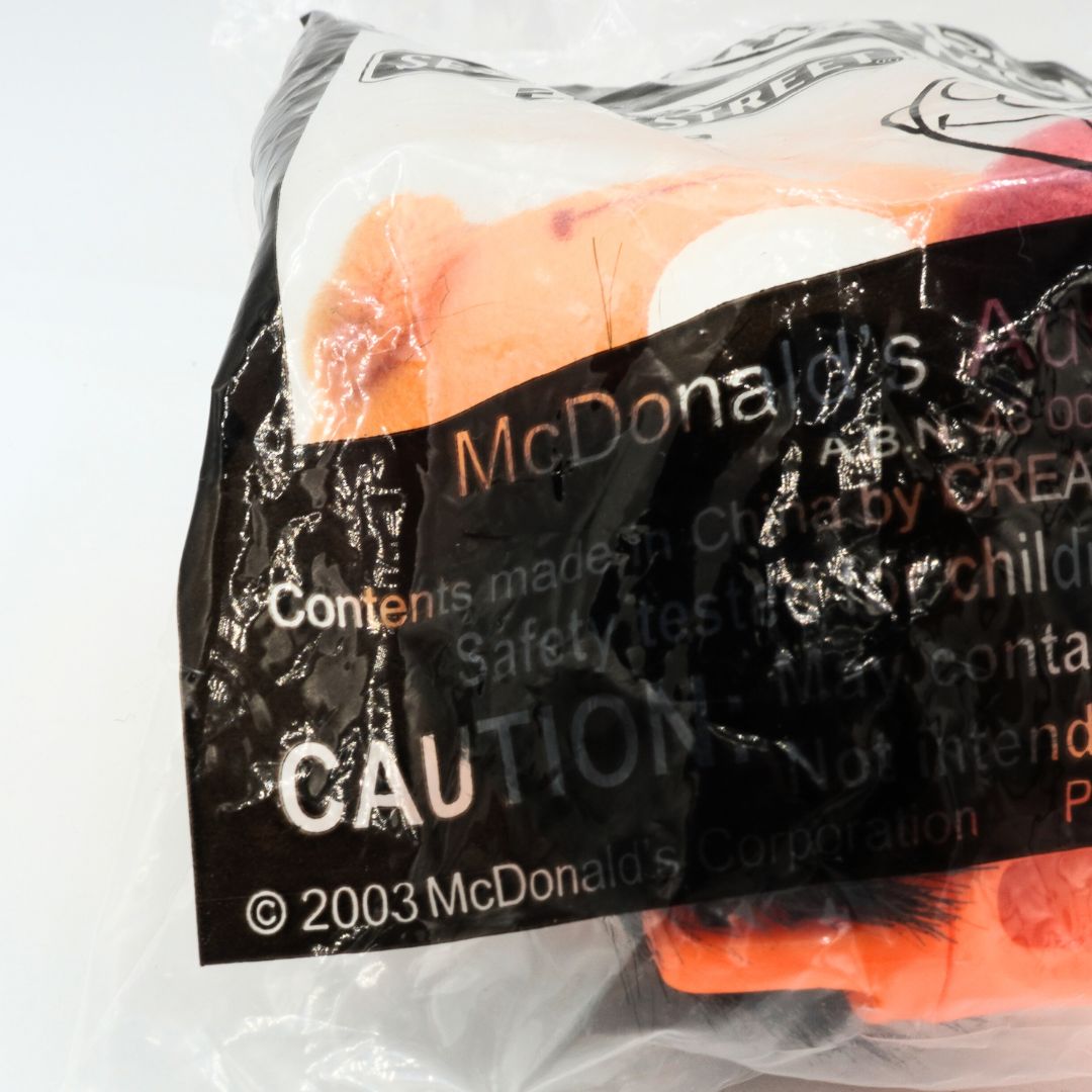 Plush toy in a McDonald's branded packaging with visible text.