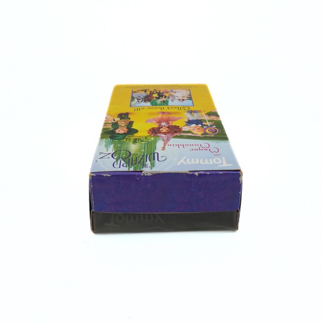 Top down photo of the Tommy as Munchkin doll box showing some wear