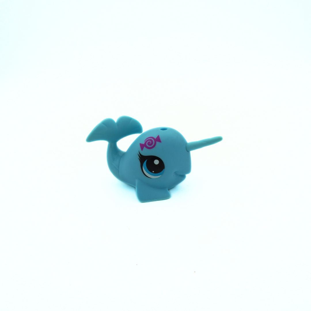 Blue toy narwhal on a white background