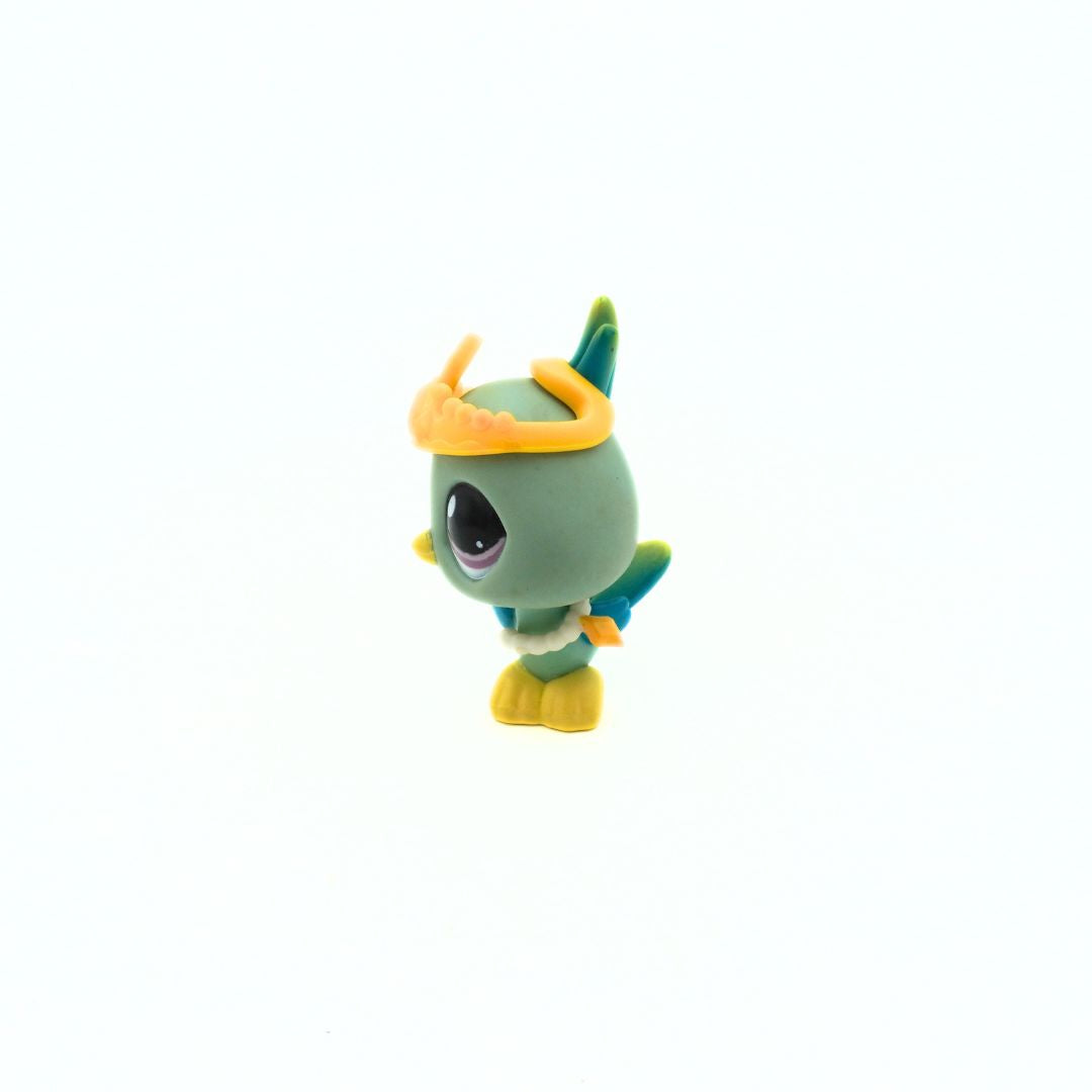 Small green figurine with a yellow hat on a white background