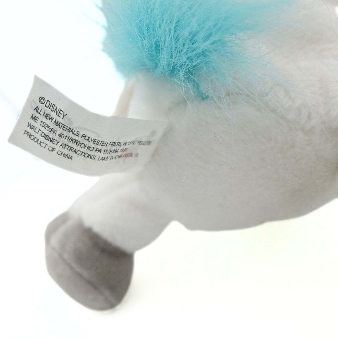 Close up of a tag showing materials and manufacturer information on a vintage Disney Pegasus plush