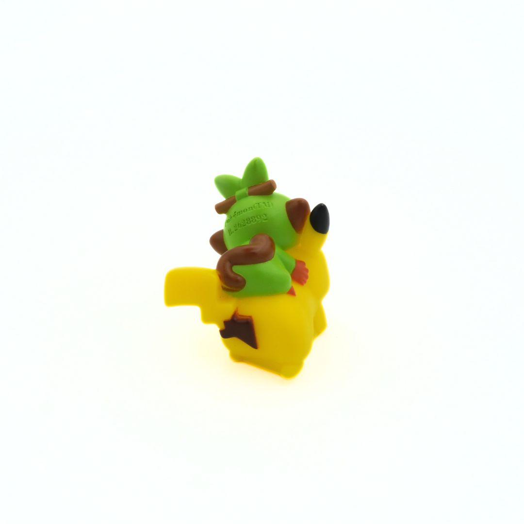A hard plastic mini-figure of the Pokemon Pikachu and Grookey seen from behind