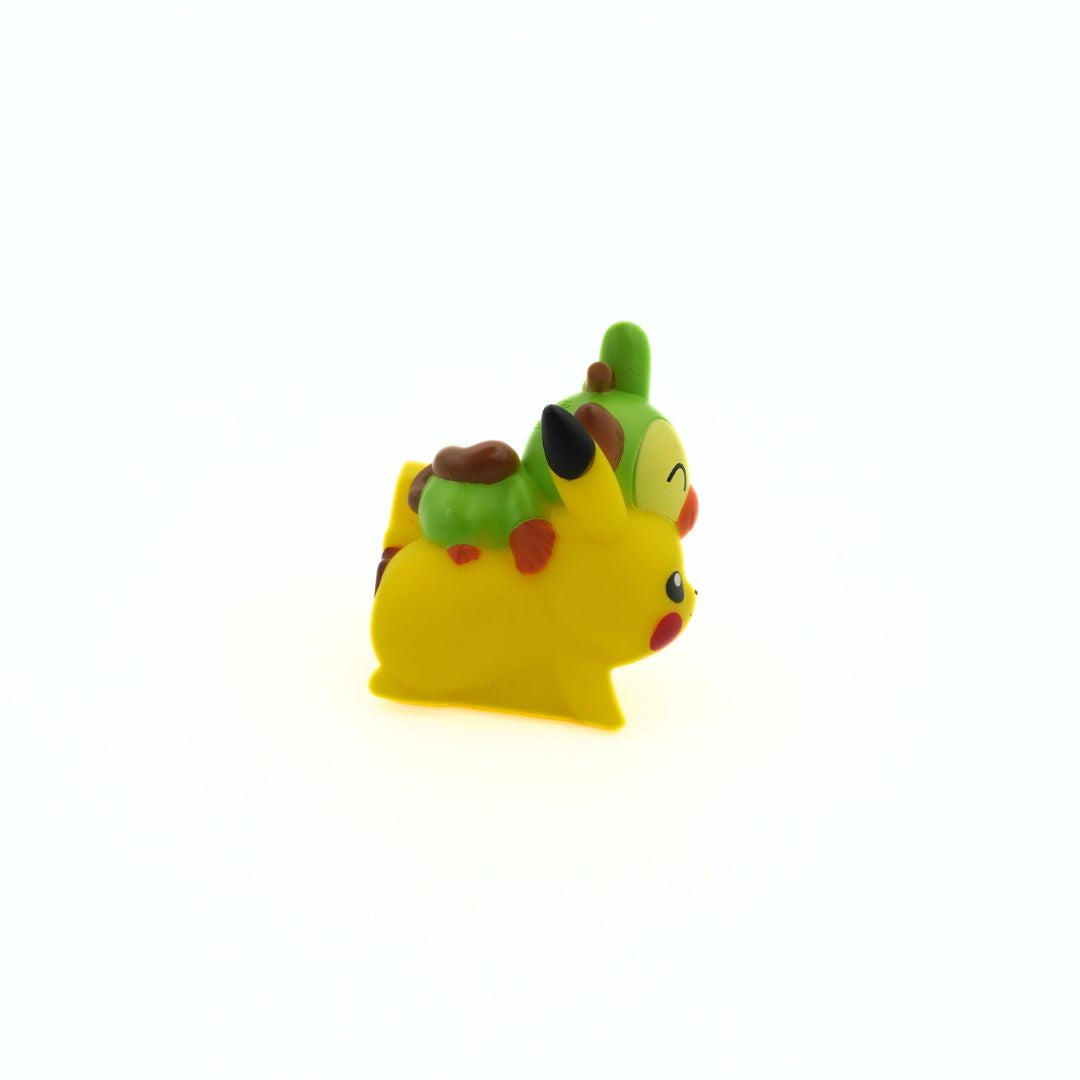 A hard plastic mini-figure of the Pokemon Pikachu and Grookey, seen from a side on angle