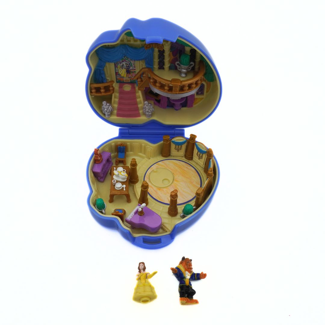Toy set with characters from 'Beauty and the Beast' in a small, open toy house.