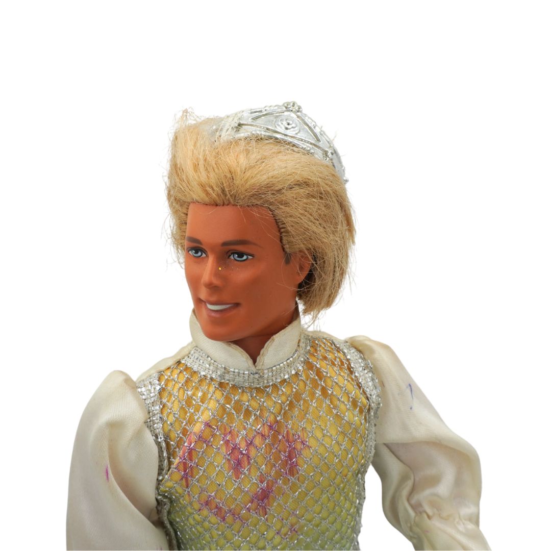 Toy figure of a character with blonde hair and a tiara on a white background