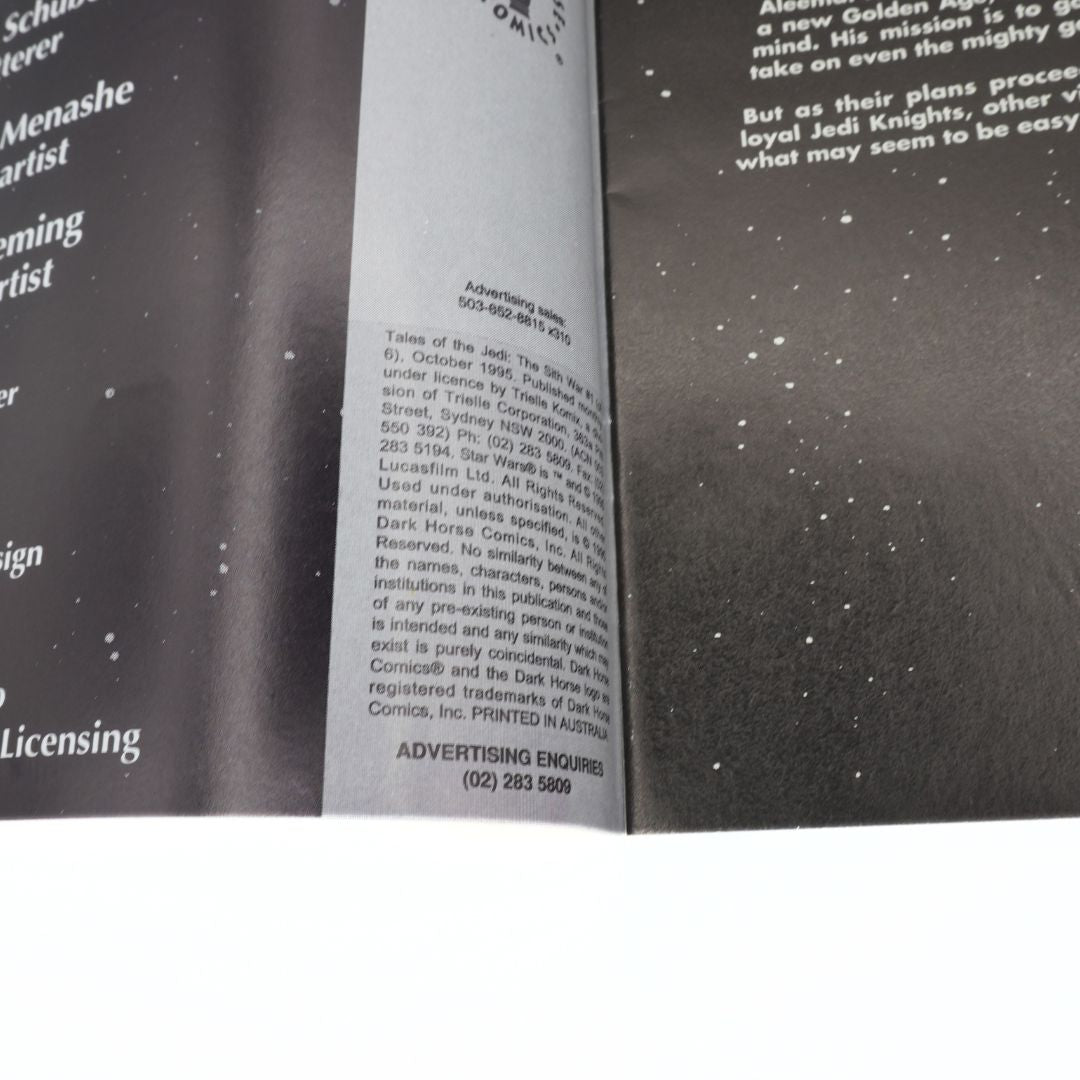 Close-up of a book with text and a black and white pattern on the cover
