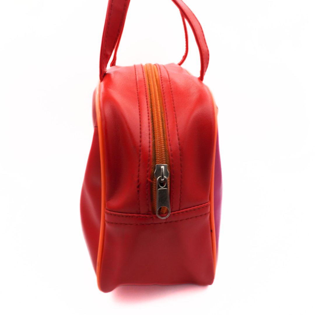 Side on picture of a vintage red Tweety Bird bag