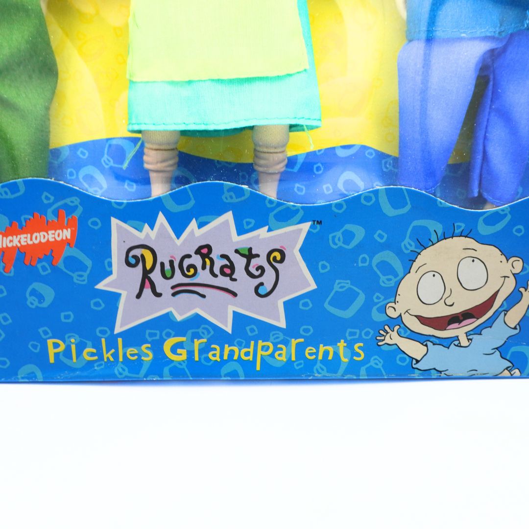 Cartoon character packaging with 'Rugrats' and 'Pickles Grandparents' text on a blue background.