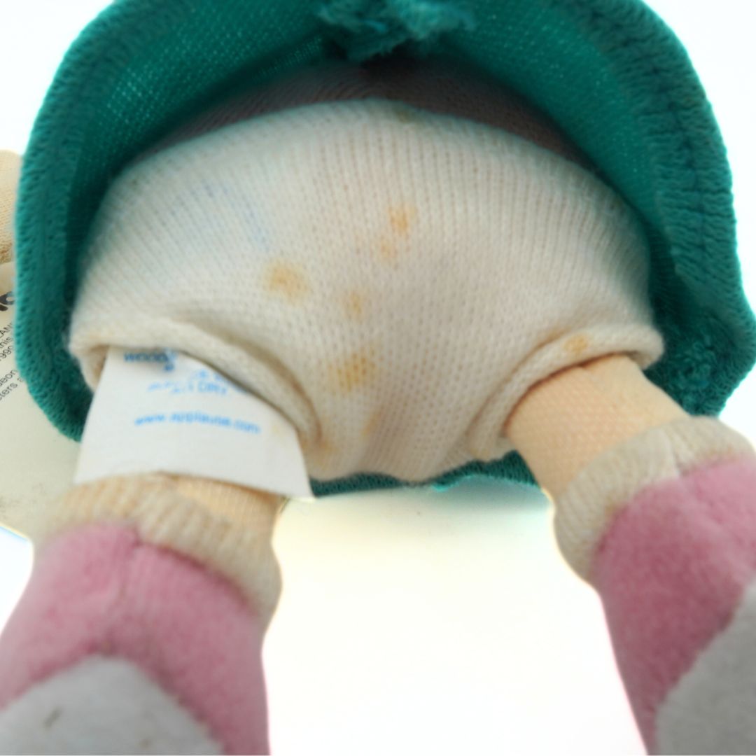 Closeup of a vintage 1999 Lil Deville underside showing stains to the toy nappy